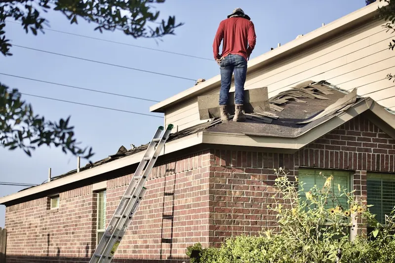 Professional roofer working on a residential roof in Hoosicks Mill